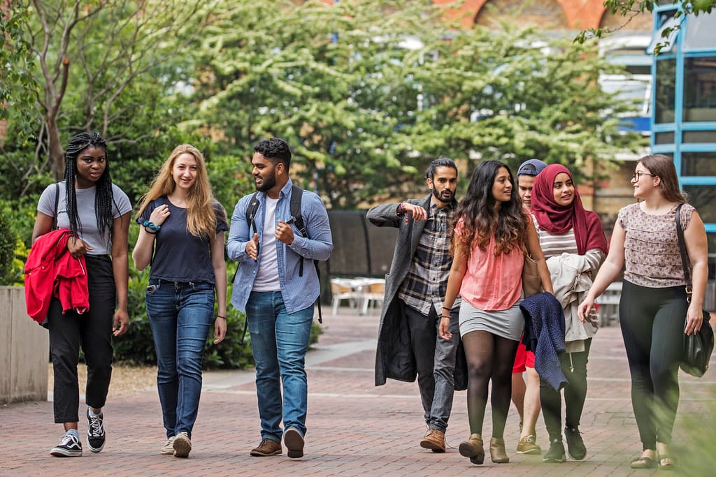 A student walking on a university campus in the UK
